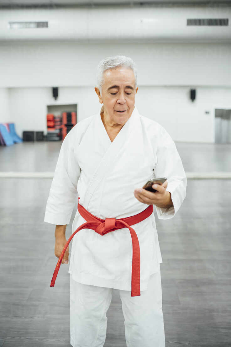karateka with mobile phone